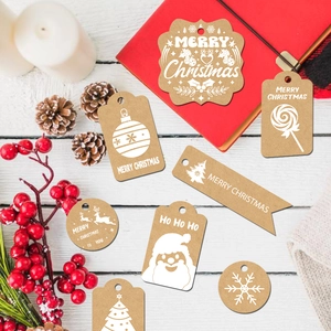 Christmas kraft paper gift tags with string and festive patterns on white wood background