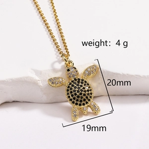 Detail view of turtle pendant with black and clear stones, dimensions 20mm by 19mm