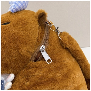 Close-up of plush Capybara backpack featuring soft brown fur, zipper detail and blue plaid trim