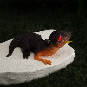 Detailed view of the 3D realistic dinosaur resin mold showing red eyes and scale texture