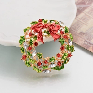 Detail of a Christmas wreath brooch with red enamel bow and sparkling rhinestones
