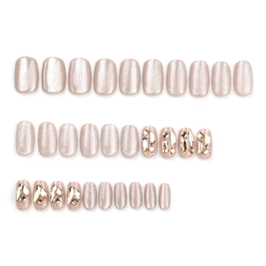 Champagne cat eye press-on nails set with glitter and 3D rhinestones on white background