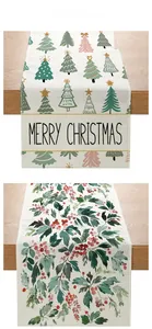 Detail of Christmas table runners with printed trees, holly leaves and Merry Christmas text