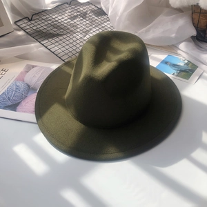 Detail of dark green wool fedora with a flat wide brim and fine felt texture