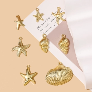 Detailed view of golden starfish and seashell charms for DIY jewelry accessories