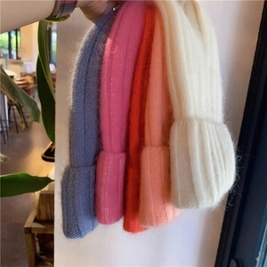 Detailed knit texture and color options including blue pink orange and cream beanies