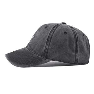 Detailed side view of washed cotton baseball cap showing vintage texture and stitching