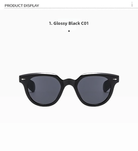 Close-up of black retro sunglasses featuring silver arrow rivets and dark gray lenses