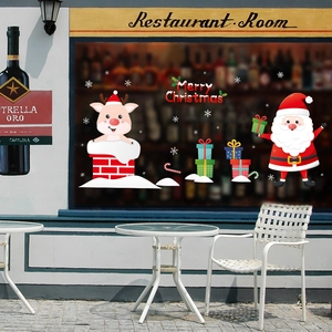 Detail of Christmas window stickers featuring Santa Claus, reindeer, and Merry Christmas text