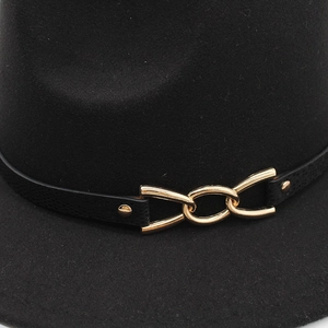 Detailed close-up of wool felt jazz hat with black leather band and gold metal chain buckle
