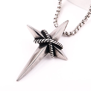 Close-up of silver stainless steel cross star pendant with a box chain in retro style