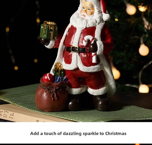 Detail of resin Santa Claus figurine with gift box and candy cane in a cozy festive setting