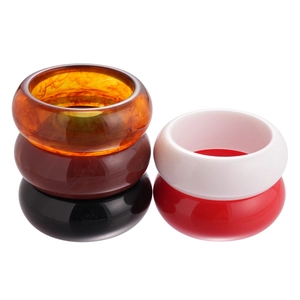 Polished acrylic resin bangles in amber, brown, black, white, and red geometric styles