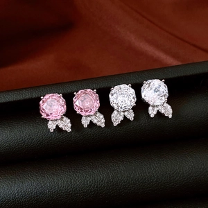 Macro detail of ice flower rose stud earrings with zircon petals and silver leaf accents
