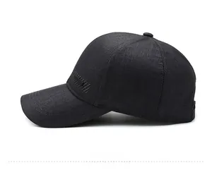 Side view detail of black polyester baseball cap showing fine mesh texture and embossed logo