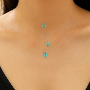 Three-layer invisible fishing line necklace with blue teardrop glass pendants on a model