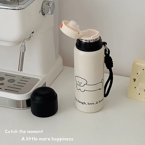 White stainless steel vacuum flask with cartoon dog pattern and black carrying strap