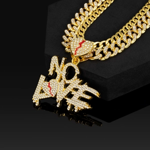 Detail of gold Cuban chain and NO LOVE pendant with red broken heart and rhinestones