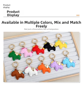 Macro detail of various colorful leather horse charms with gold keychains in a display box