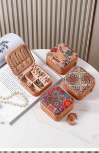 Detail of vintage cork texture jewelry boxes with patterned lids on white marble