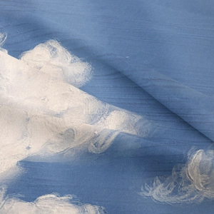Detailed close-up showing the soft texture and blue sky cloud pattern on the tapestry fabric