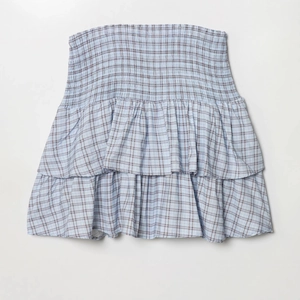 Women's light blue plaid smocked mini dress with double-layered ruffle hem