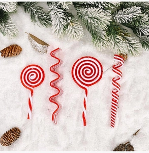 Red and white acrylic candy cane ornaments and swirls on snow background decor