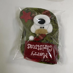 Close-up of a green Christmas stocking with white bear detail and Merry Christmas embroidery