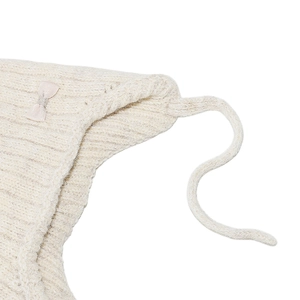 Detailed close-up of cream knit bonnet for girls with ribbon bow and ribbed texture