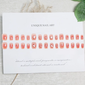 Short blush gradient press-on nails with white lines, pearls and 3D heart charms