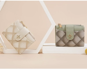Detail of quilted leather texture and gold flower clasp on beige and green small wallets