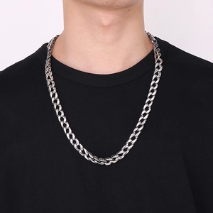 Macro detail of men's Cuban link chain necklace in antique silver finish on black T-shirt