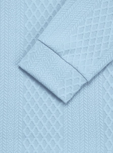 Detailed macro view of light blue knitted fabric with geometric diamond texture patterns