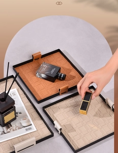 Close-up of woven leather storage trays for cosmetics and keys in brown and beige colors