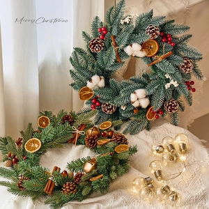 Christmas wreath with pine needles, pine cones, and orange slices for wall decoration