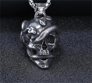 Macro detail of gothic snake skull pendant with vintage oxidized finish on steel