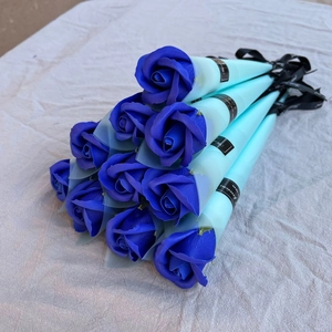 Close-up of 10 blue soap roses individually wrapped in light cyan paper with black ribbons