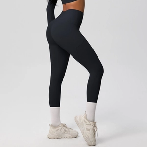 Detail view of high-waist black yoga leggings with hidden side pocket and peach lift effect