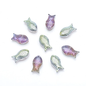 Macro shot of fish-shaped iridescent beads with purple and gold gradient finish