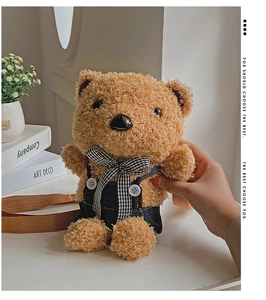 Detail of plush teddy bear crossbody bag with checkered overalls and adjustable straps
