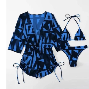 Flat lay of a three-piece swimsuit set with blue geometric print mesh cover-up romper