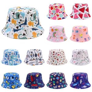 Detail view of various kids sun hats featuring colorful dinosaur and unicorn prints