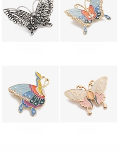 Detailed grid of crystal butterfly brooches with colorful enamel and pearl accents