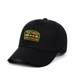 Detail of Retired Drug Dealer embroidery on black cotton baseball cap with patch