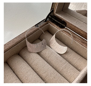 Detail of S925 sterling silver stamp on brushed metal arched earring hook