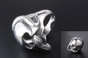 Macro detail of silver skull and snake ring showing metallic scale texture and rock punk style