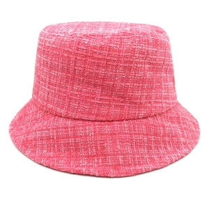 Close-up of pink tweed bucket hat showing textured weave and premium stitching details