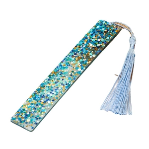 Handmade clear acrylic bookmark with colorful sequins and a light blue tassel accessory