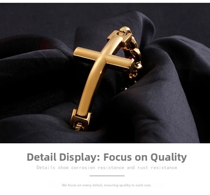 Detailed close-up of a gold cross pendant on a heavy Cuban link chain against black silk