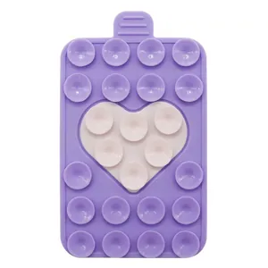 Detail of purple silicone phone suction pad with white heart design and dual suction cups